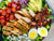 Cobb Salad Romaine, Ham, Turkey, American Cheese, Swiss, Grape Tomato, Boiled Eggs, Bacon  & Onion 320oz bowl